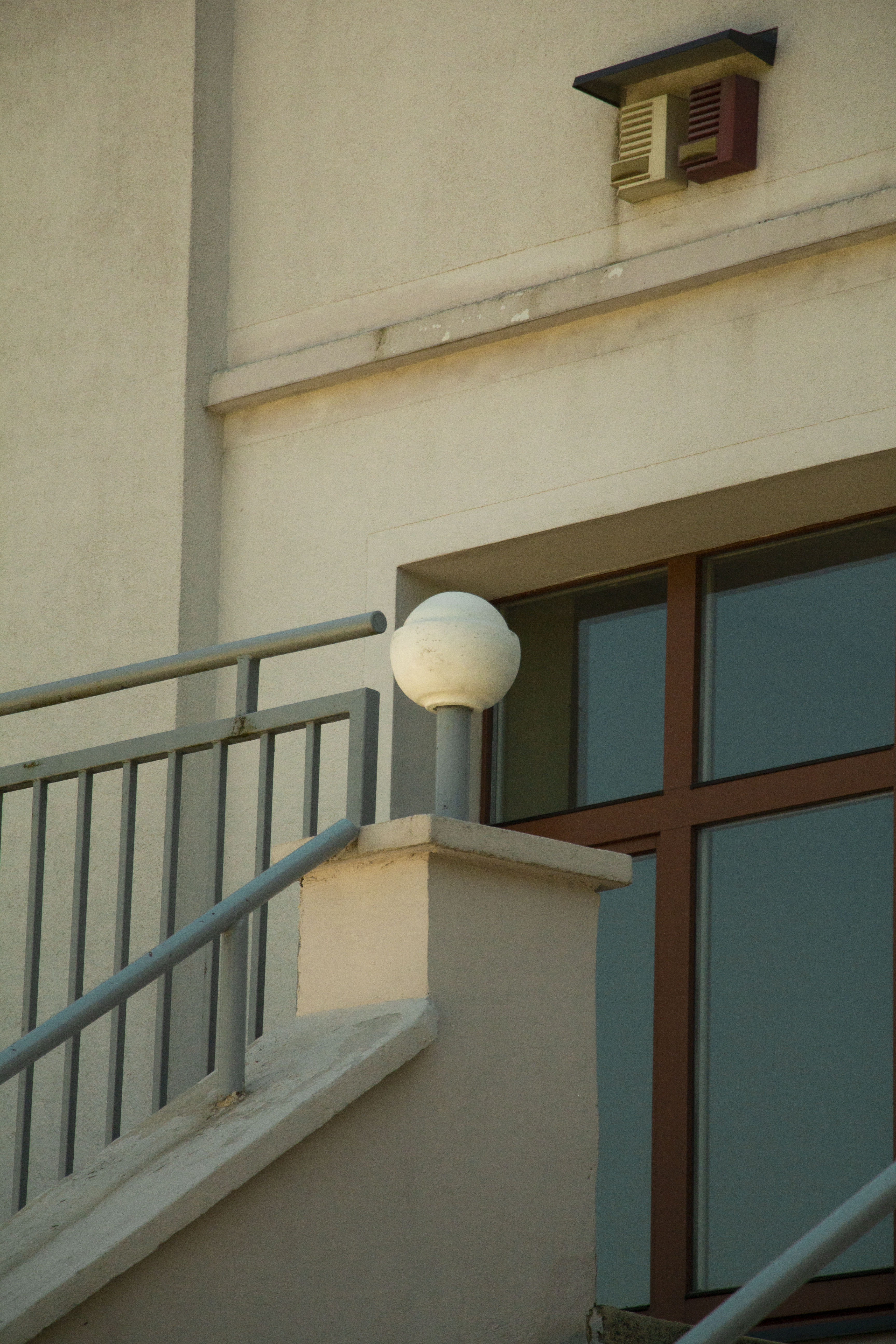 a white ball sitting on the side of a building