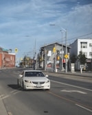 Instructor guiding a student driver through a calm neighborhood street.