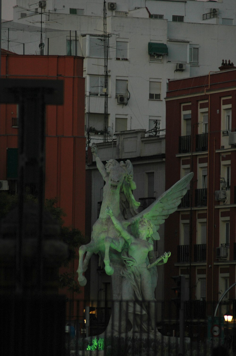 a statue of a woman riding a horse in a city