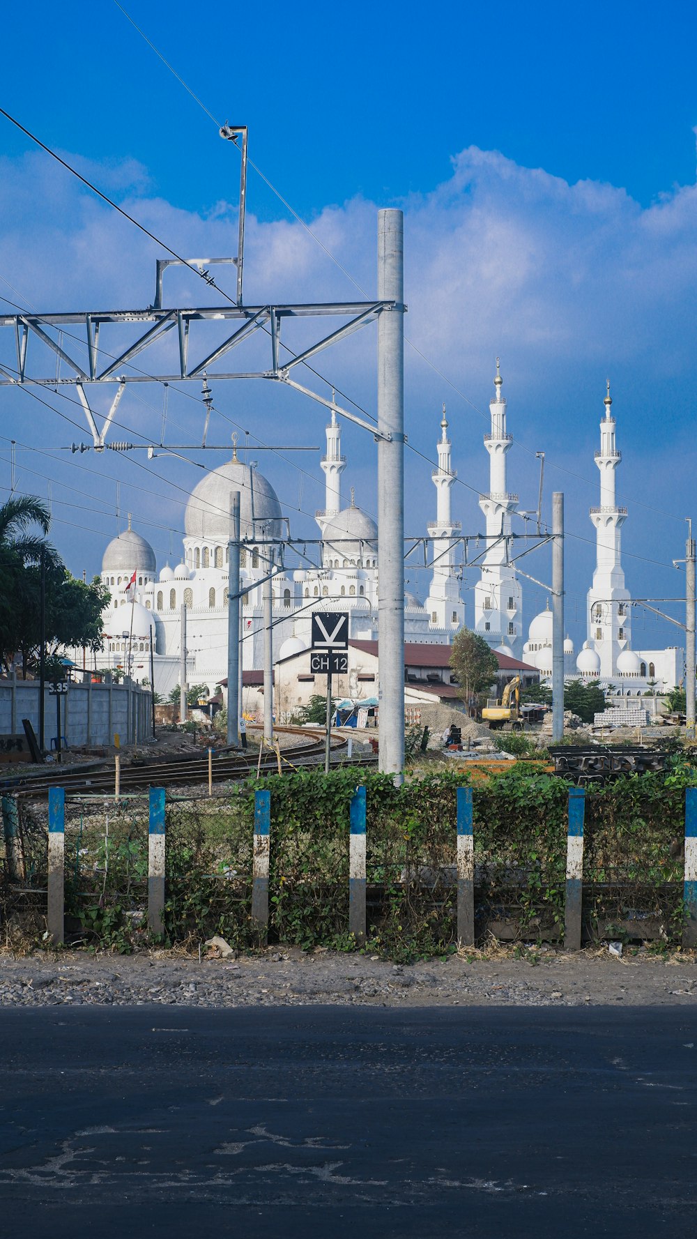 a large white building sitting next to a road