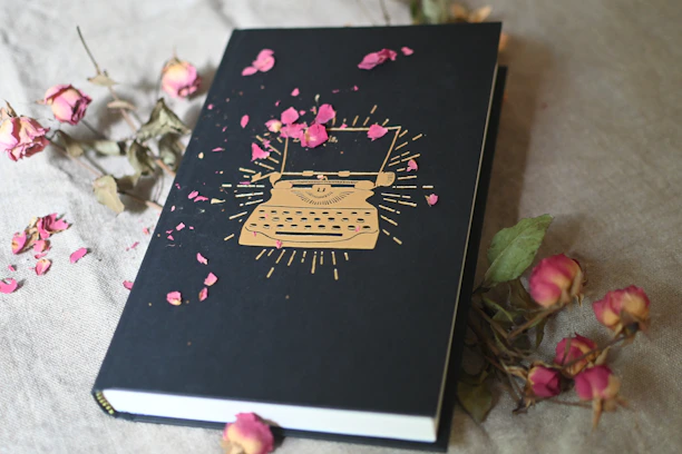 Artistic shot of a vintage-style notebook with elegant typography and colors inspired by Jowdean Creations' palette.