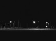 Nighttime scene showing the contrast between the bright floodlights and the surrounding darkness.