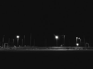 Nighttime scene showing the contrast between the bright floodlights and the surrounding darkness.