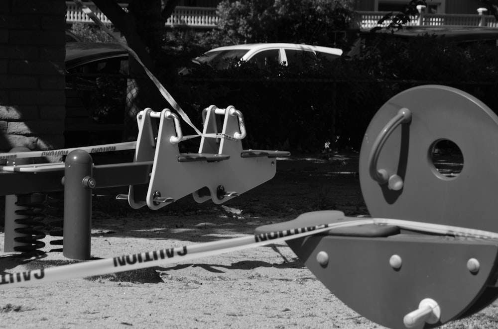 a black and white photo of playground equipment