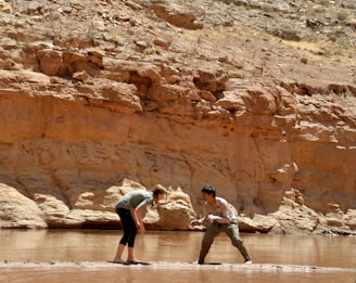 a couple of people that are standing in the water