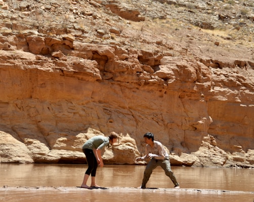 a couple of people that are standing in the water