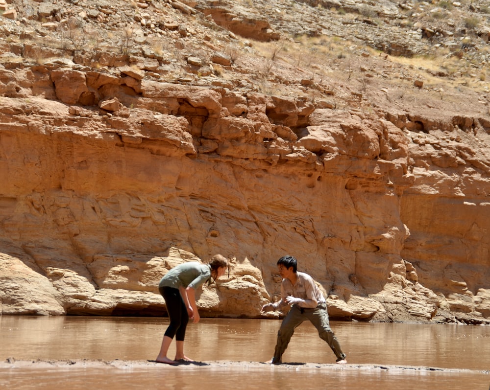 a couple of people that are standing in the water