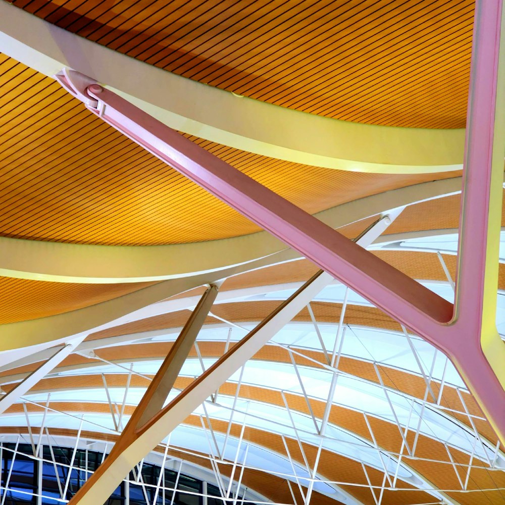 the ceiling of a large building with a wooden structure