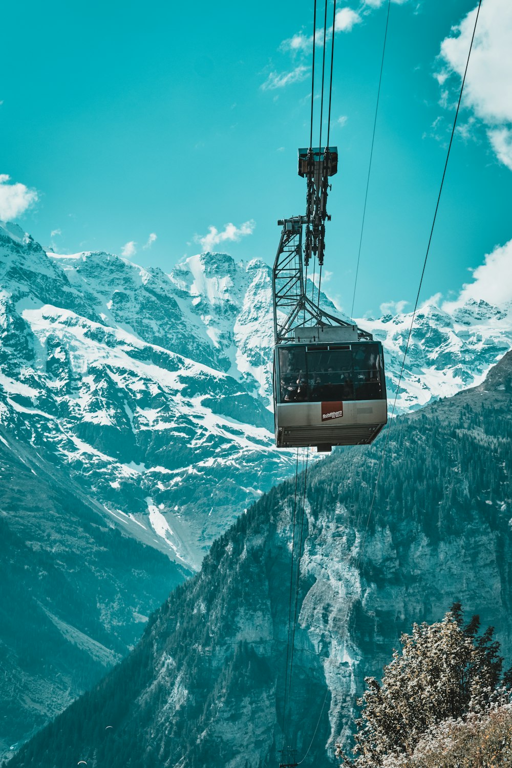 a cable car going up the side of a mountain