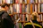 Two installers carefully assembling a large bookshelf in a cozy home office.