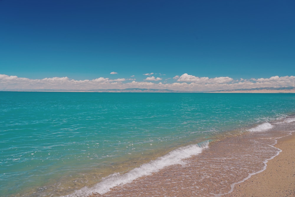 a view of the ocean from the shore of a beach