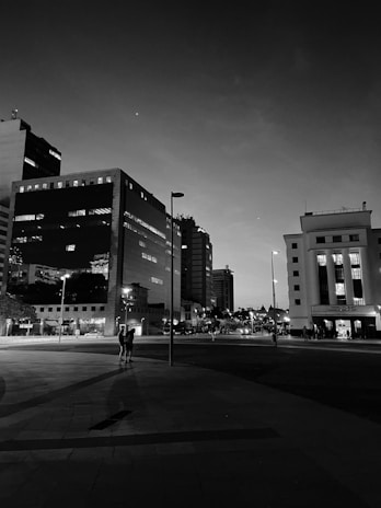 Black and white cinematic shot of a Miami cityscape at dusk, highlighting urban textures and light contrasts.