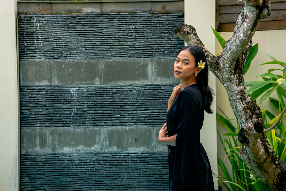 a woman standing in front of a water fountain