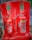 Two fire extinguishers are positioned on a red stand, one labeled as CO2 and the other as Foam. Both extinguishers have instructional labels with icons and text, indicating their uses and safety precautions.