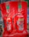 Two fire extinguishers are positioned on a red stand, one labeled as CO2 and the other as Foam. Both extinguishers have instructional labels with icons and text, indicating their uses and safety precautions.