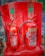 Two fire extinguishers are positioned on a red stand, one labeled as CO2 and the other as Foam. Both extinguishers have instructional labels with icons and text, indicating their uses and safety precautions.