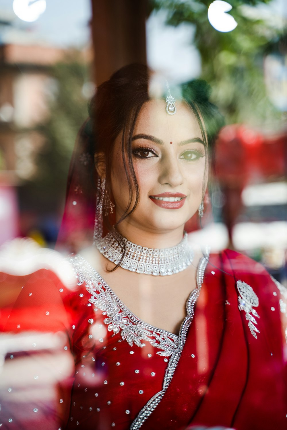 a woman in a red dress is looking out a window