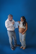 a man and a pregnant woman standing next to each other