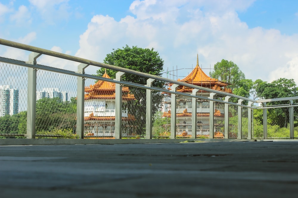 a metal fence with a building in the background