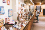 Visitors examining non-sports collectibles, including vintage toys and memorabilia, with smiles and excitement.