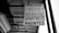 A black and white photograph of a real estate sign hanging from a building. The sign reads 'FOR LEASE' with the contact information for SHELNUTT Real Estate Enterprises. Beneath the main sign, there is an additional sign that says 'APARTMENT HAUNTED'. The angle of the photo shows the underside of a roof and support structure.