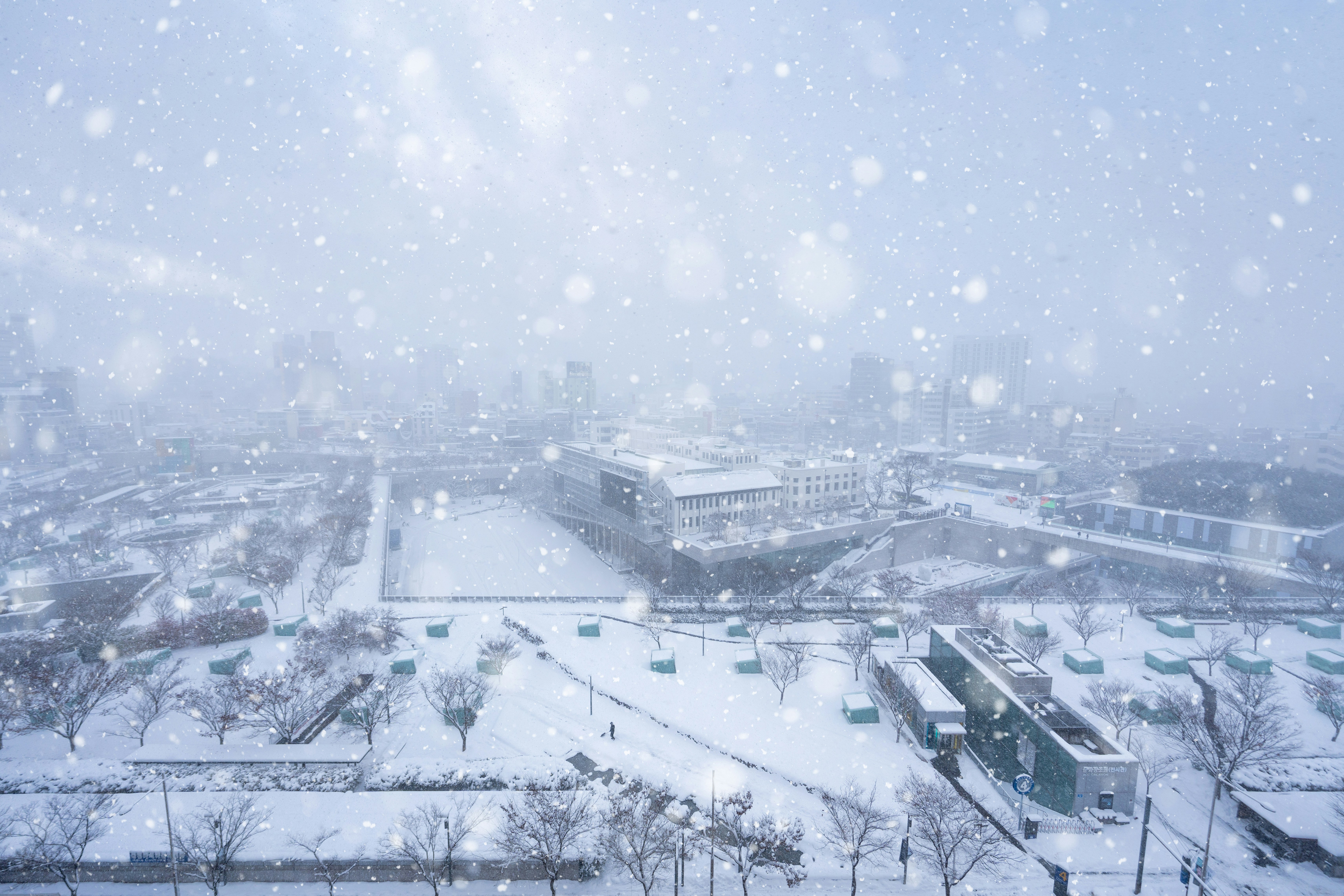 A snowy view of a city from a window photo – Free Nature Image on Unsplash