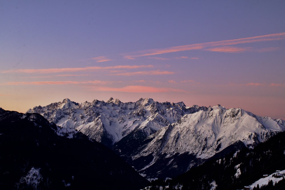 a mountain range with snow covered mountains in the background