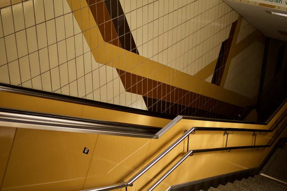 an escalator in a subway station with tiled walls