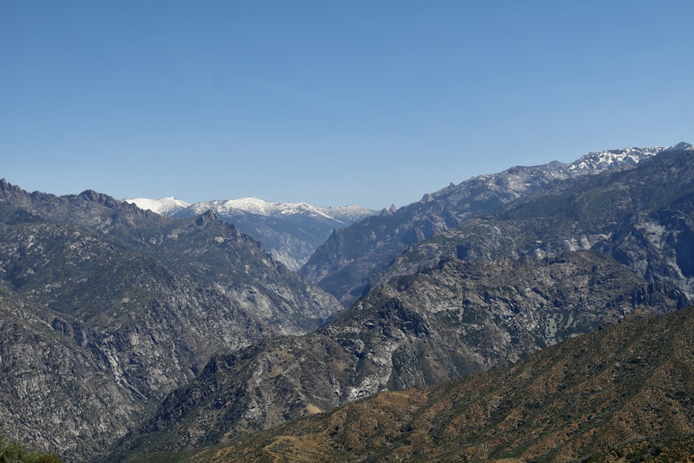 a mountain range with snow capped mountains in the background