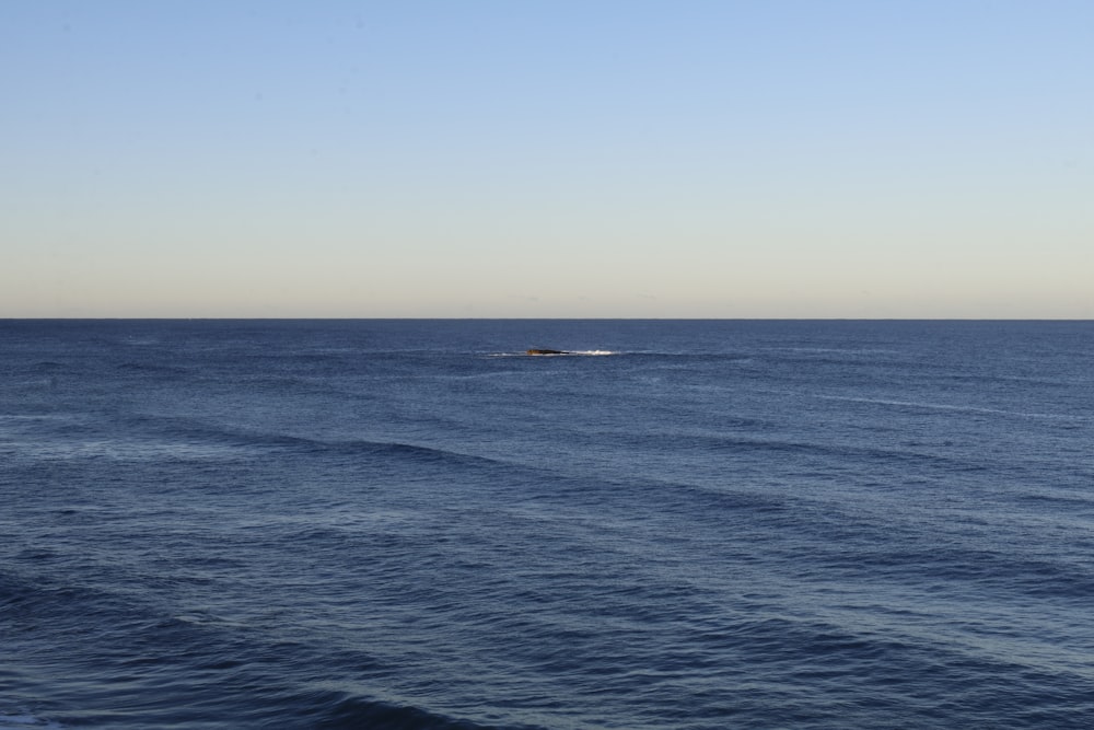 a small boat in the middle of a large body of water