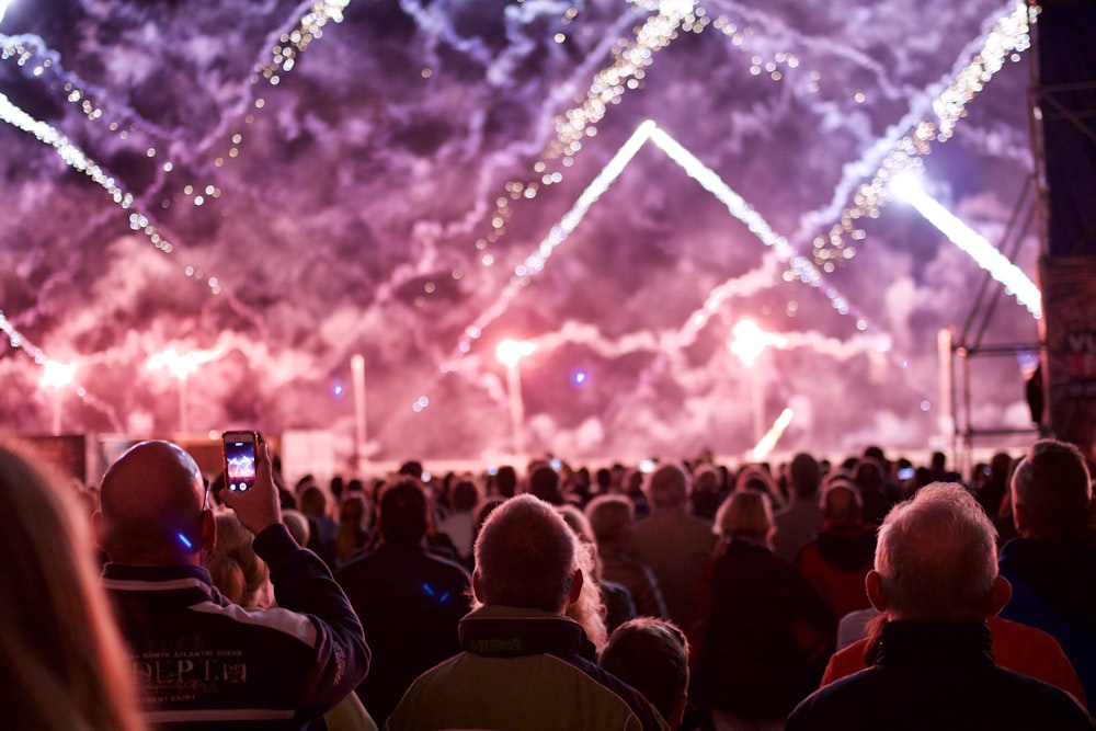 a crowd of people watching a fireworks display