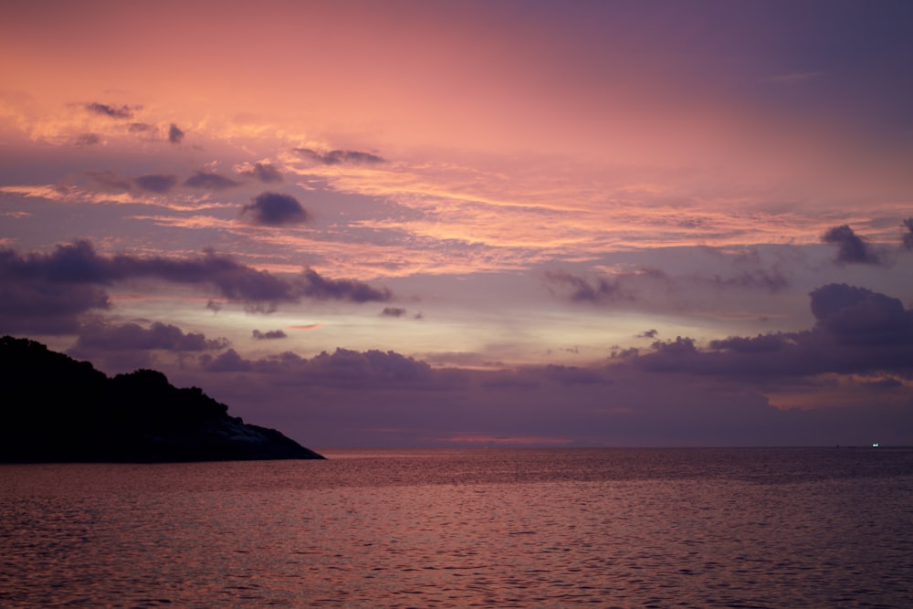 a large body of water under a cloudy sky