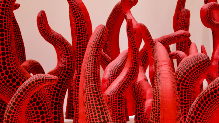 A group of red sculptures placed in sequence — quiet, repeated forms in keeping with Pavel Ostrowski's sculptural practice