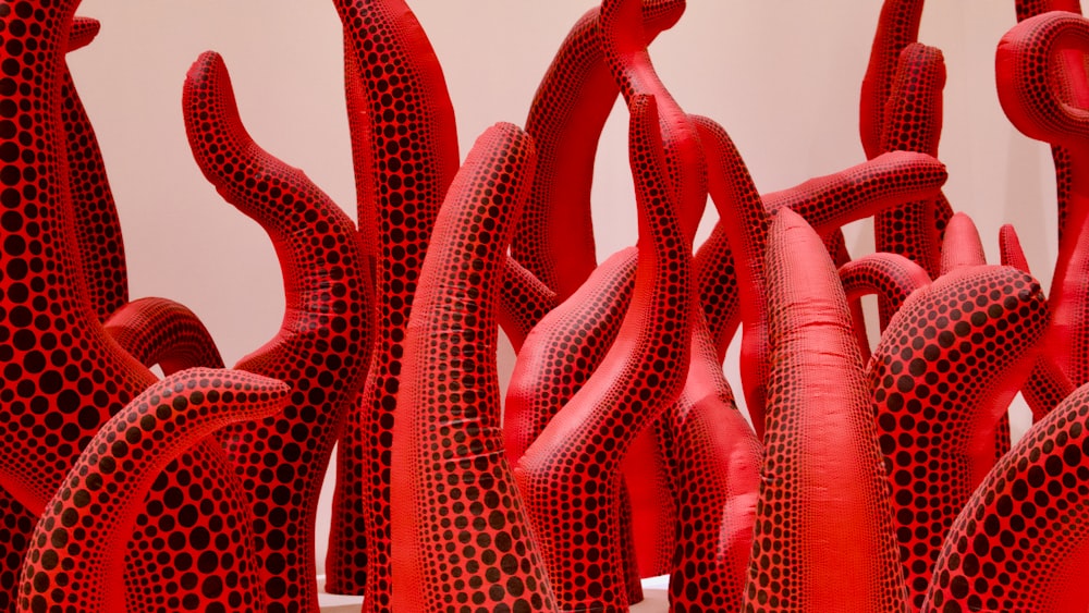 a group of red sculptures sitting next to each other