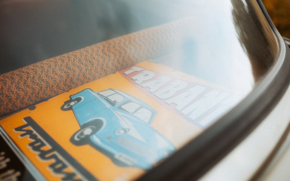 a close up of a magazine on the hood of a car
