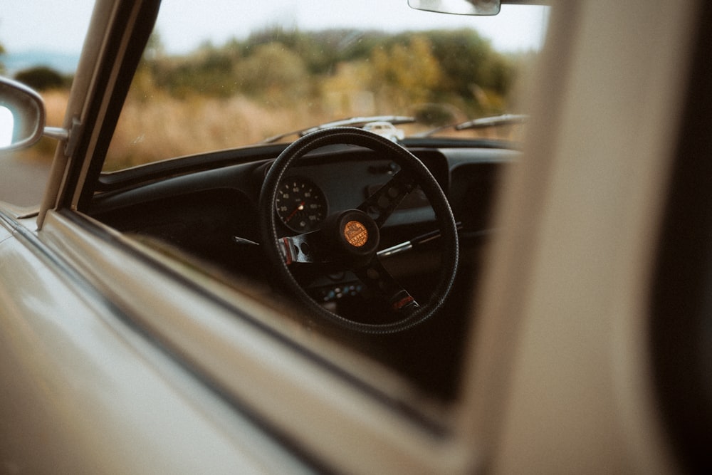 the interior of a car with a steering wheel and dashboard