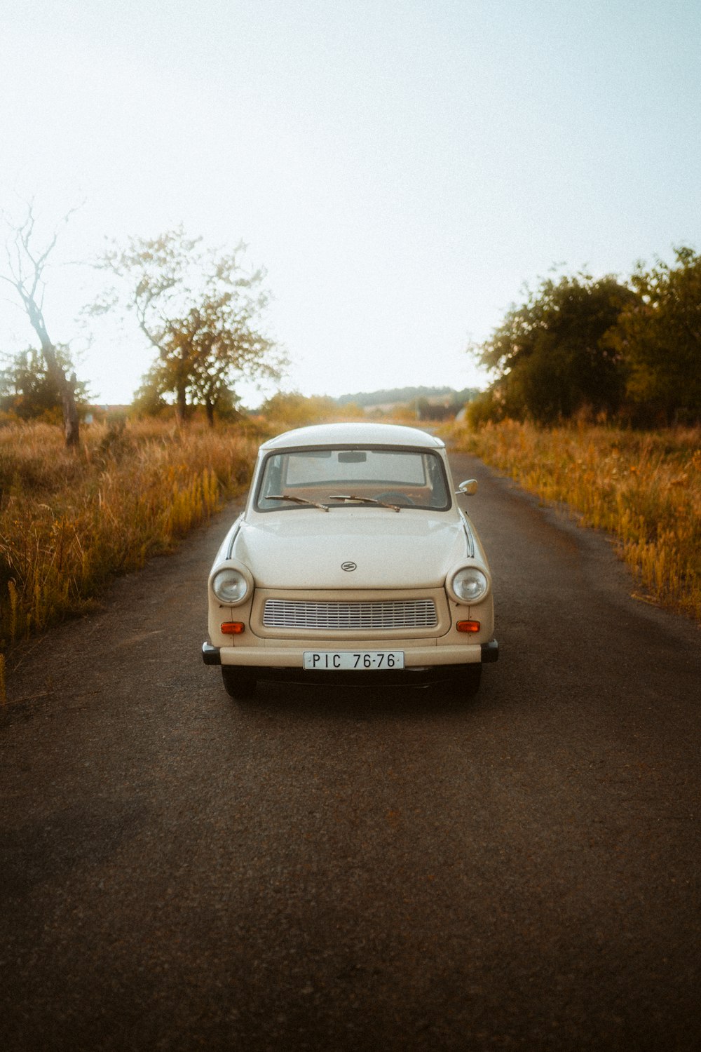 a white car parked on the side of a road