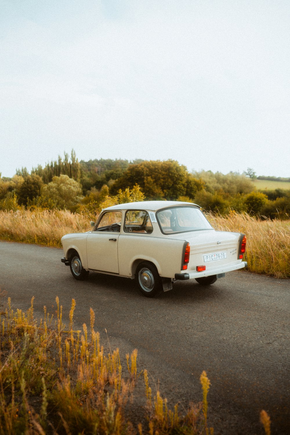 a white car parked on the side of a road