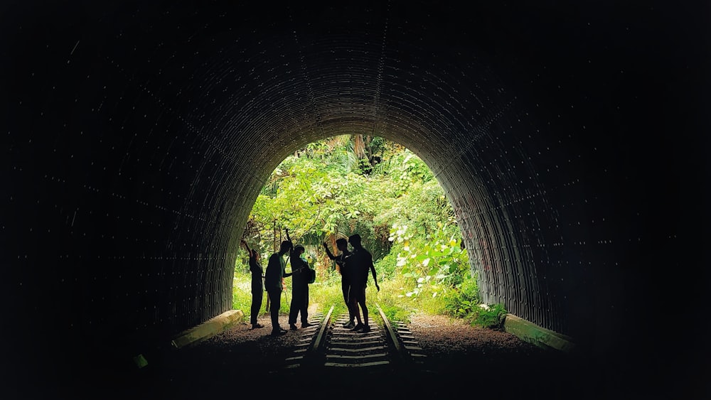 a group of people standing in a tunnel