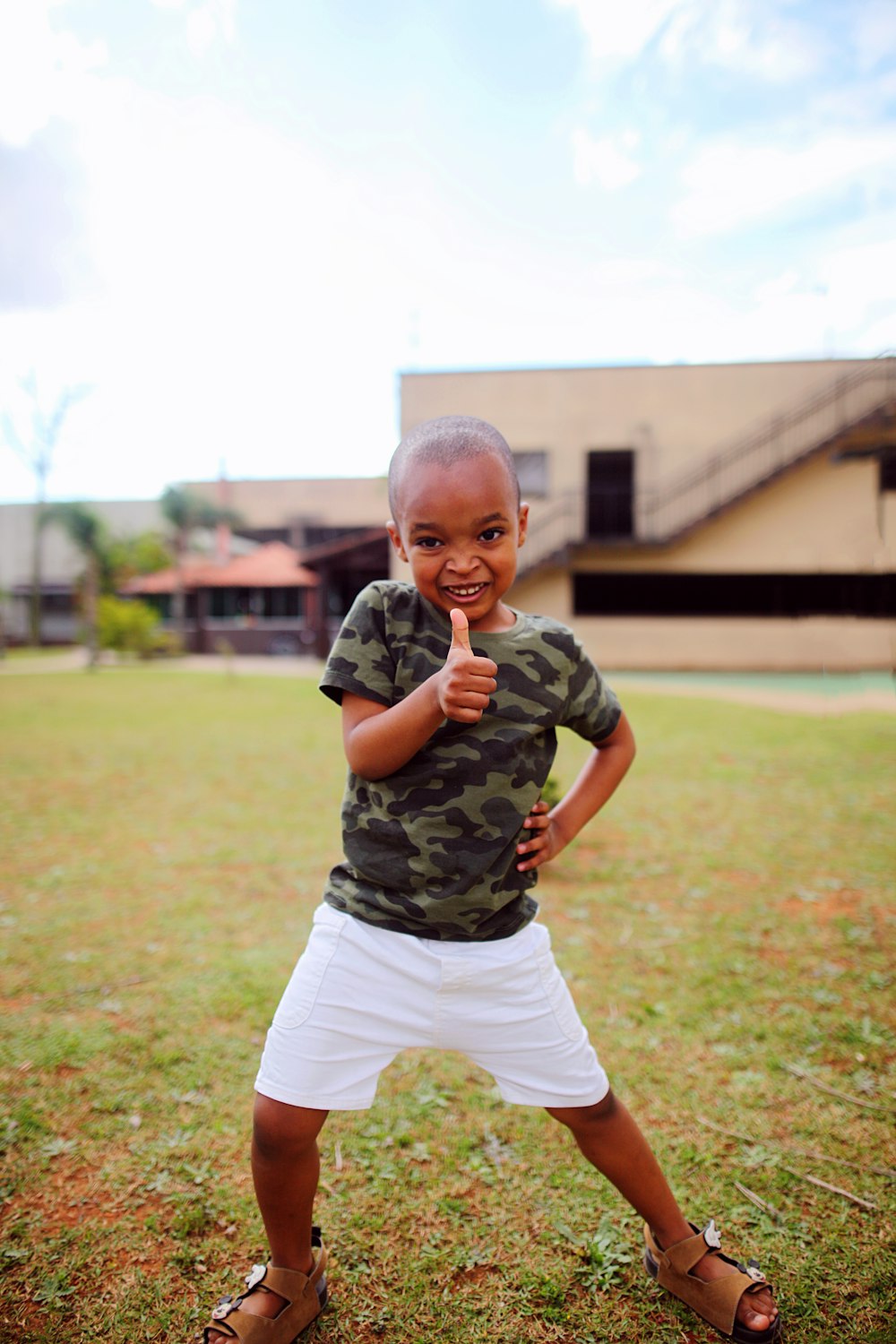 a young boy giving the thumbs up sign