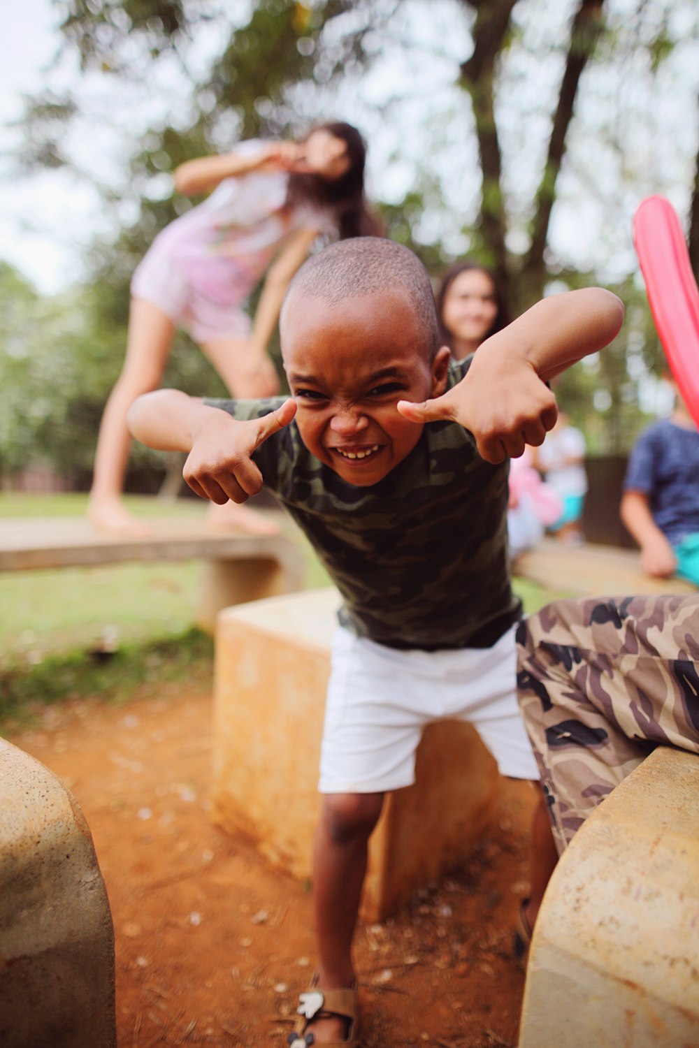 a young boy making a funny face with his hands