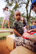 Children of veterans enjoying a summer camp activity with counselors.