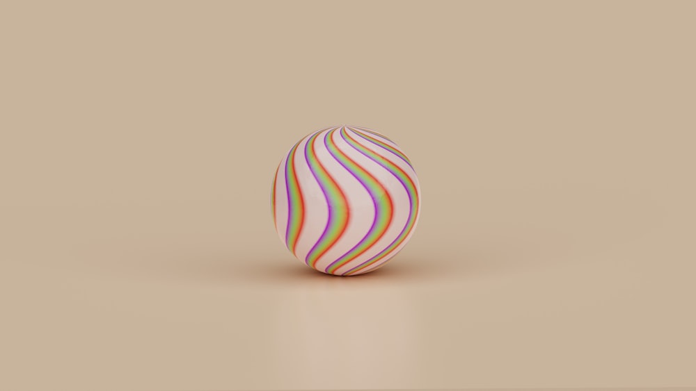 a colorful striped egg sitting on top of a table