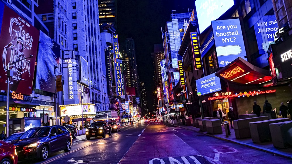 a busy city street at night with neon lights