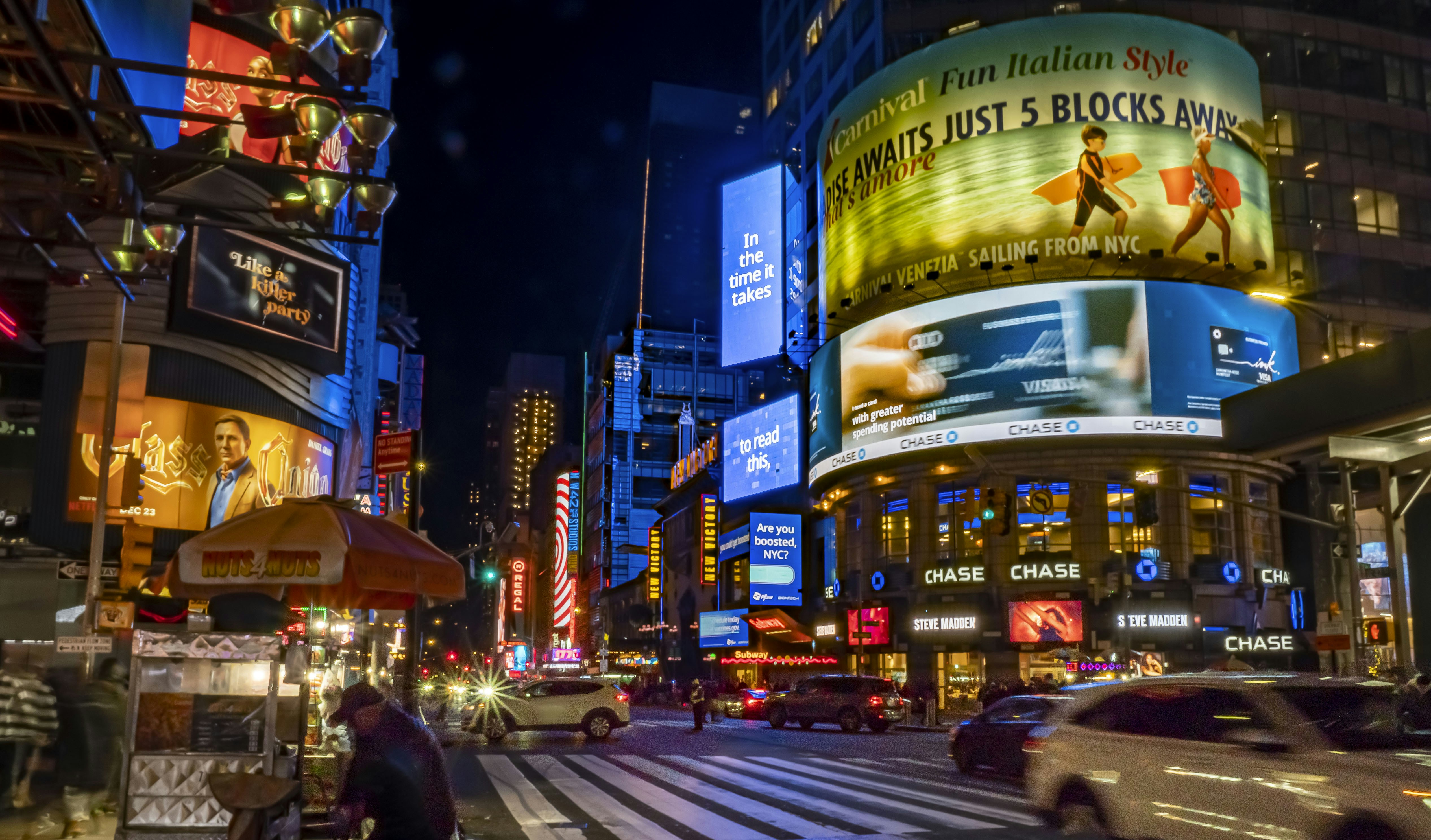 a city street filled with lots of traffic and tall buildings