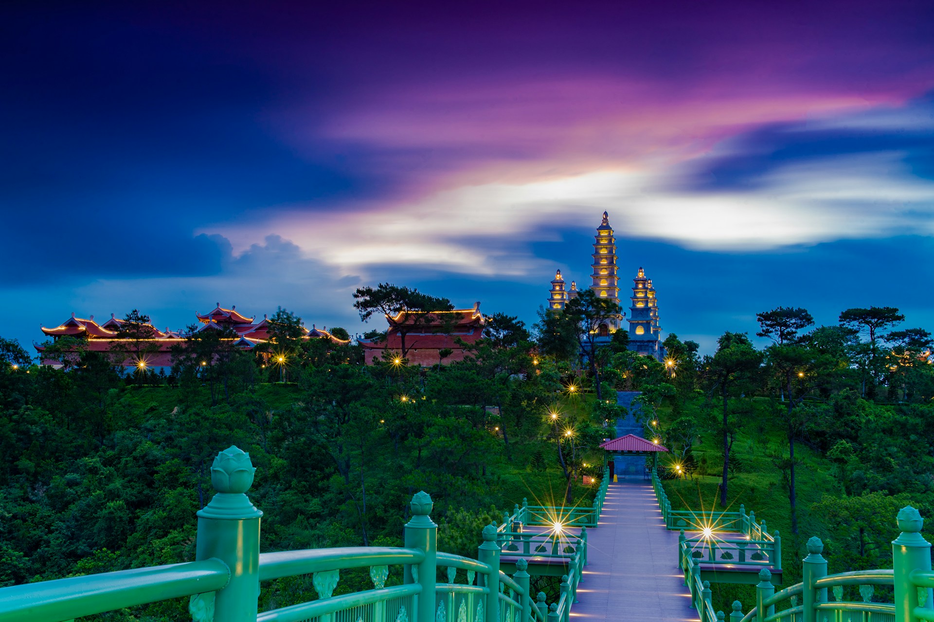 a view of a city at night from a bridge