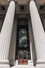 a tall building with columns and a door