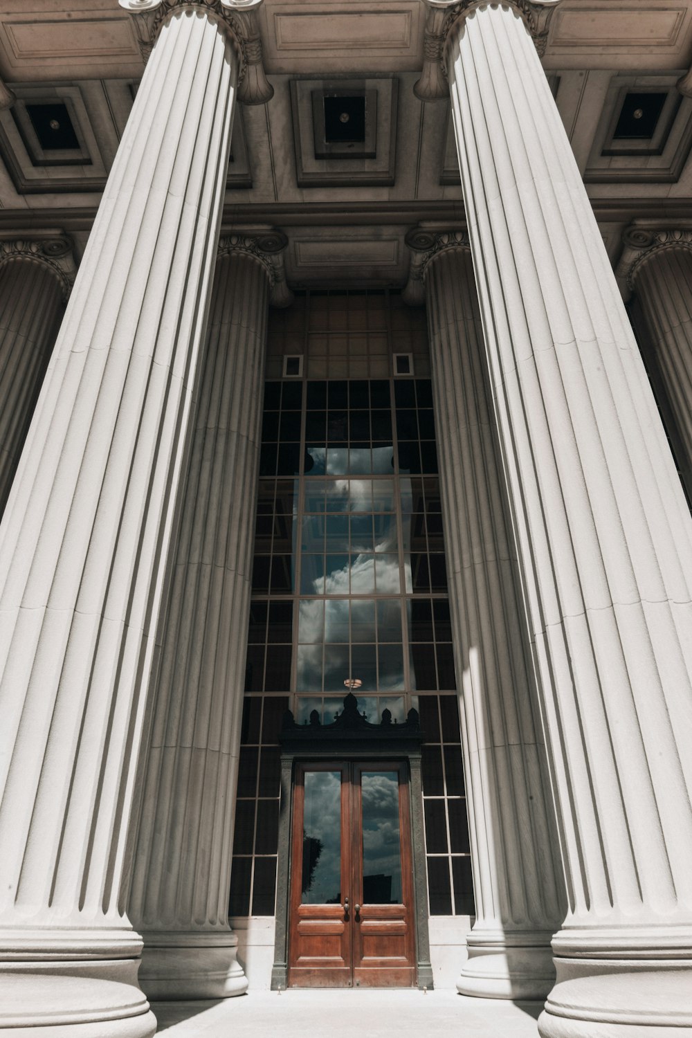 a tall building with columns and a door