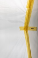 Clean removal demonstration of floor marking tape on a surface.