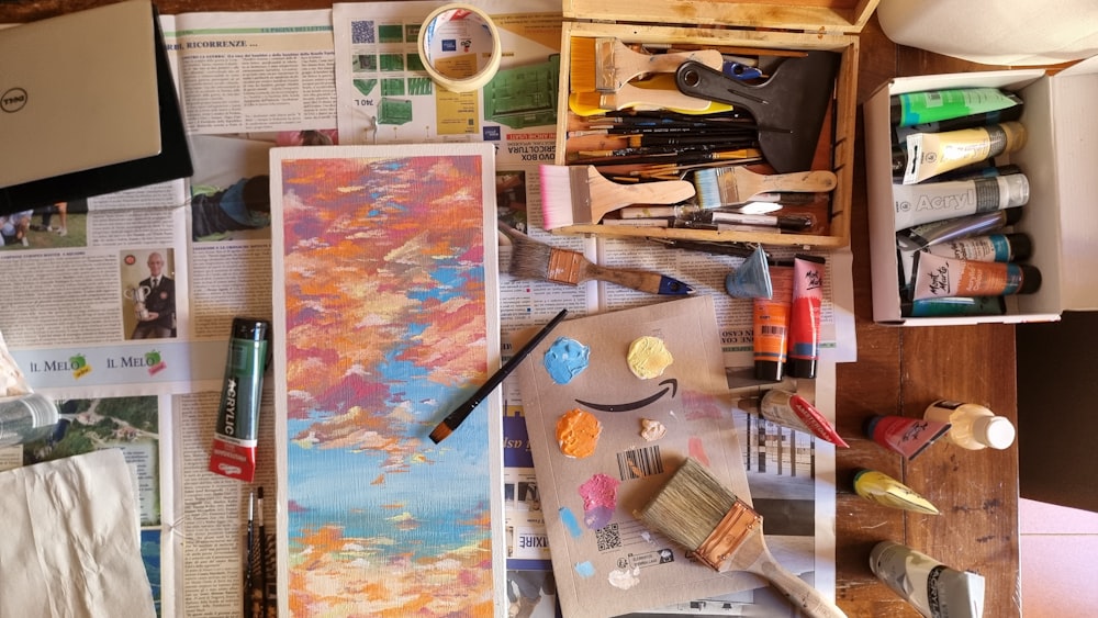 a table topped with lots of art supplies